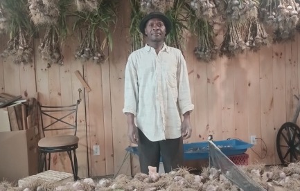 Shabagwe with his garlic harvest