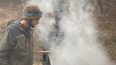 Landon checking on the maple syrup
