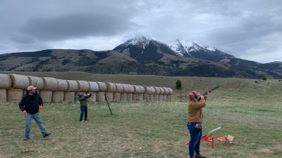Emilie (background), Liz (foreground), and their friend Collin shooting clays.